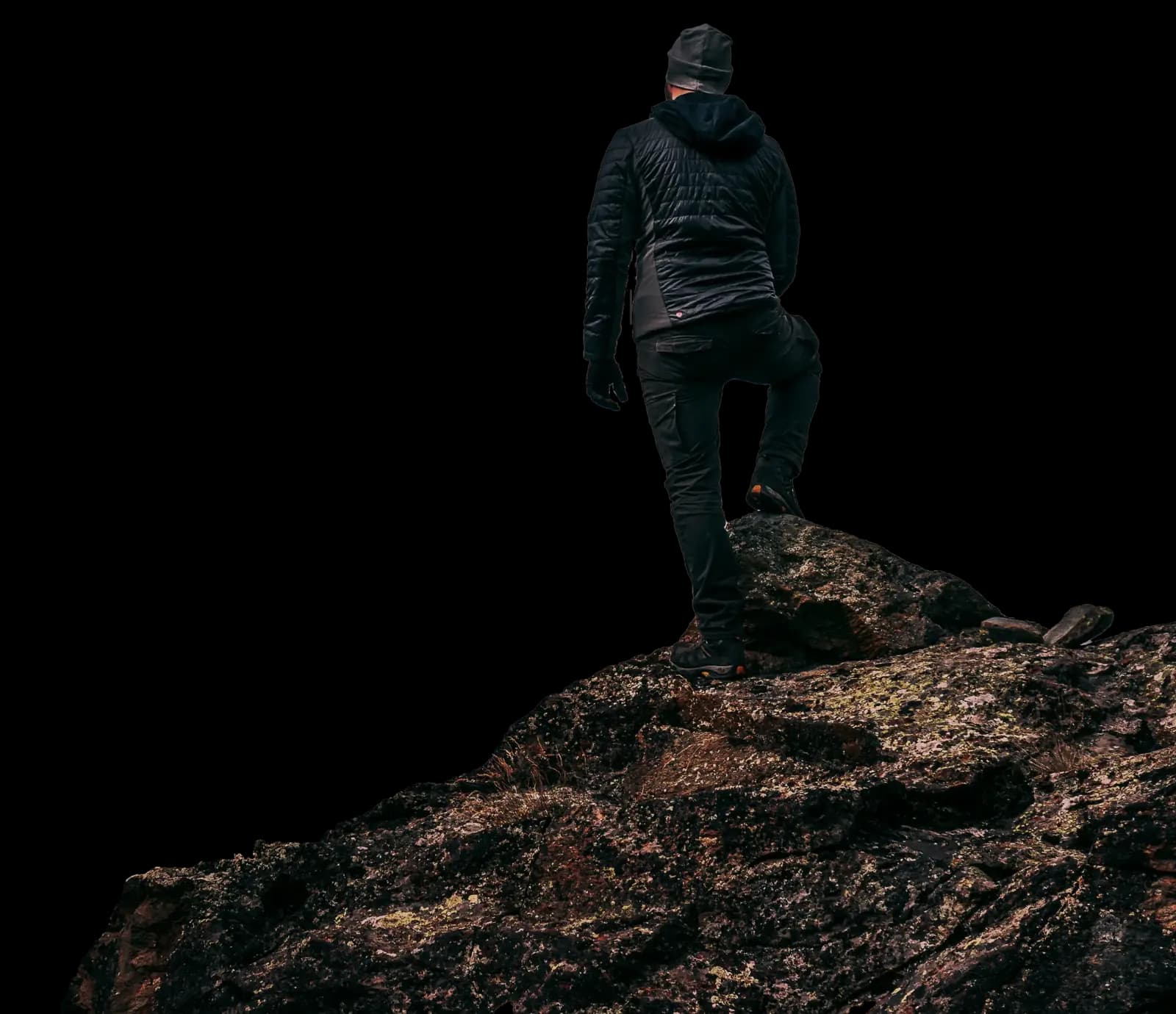 Traveler with backpack standing on mountain peak enjoying Kashmir views