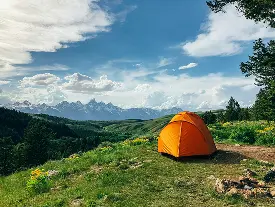 Family trekking through lush Pahalgam valley meadows